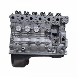 Silver automotive engine block, side view.