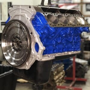 Blue engine block in a workshop setting.